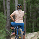 Image of the Women's Catalyst Mountain Bike Button-Down Shirt in Rhodo Tan: A high-performance jersey disguised as a stylish button-down shirt. Features a front stash pocket, built-in lens wipe, and reinforced snaps. 100% recycled with 6% Silver Ion content for natural cooling and odor control. New Tru-Fit sizing for a more feminine silhouette. UPF30 sun protection for outdoor adventures.